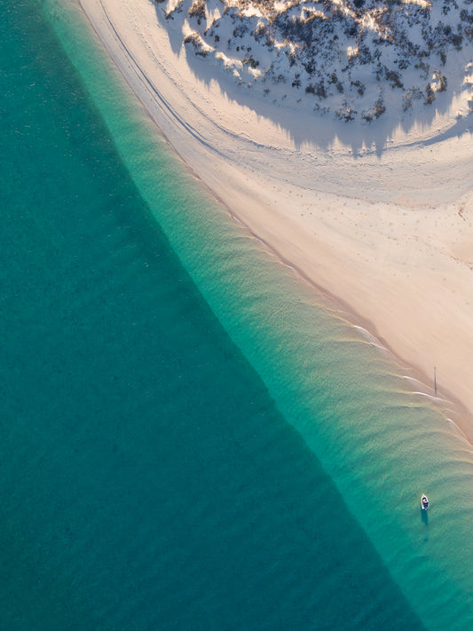 Aerial image of a boat anchored in the Dampier Archipelago